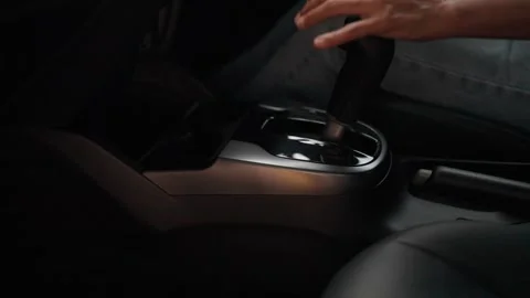 Close-up of a woman's hand adjusting the gear while driving a test drive  Stock Footage 264105464