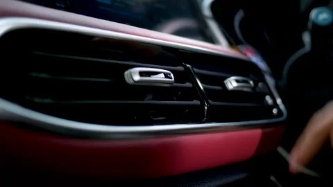 Close-up of a woman's hand adjusting the ventilation grill on the console in car Vídeo Stock 143761935