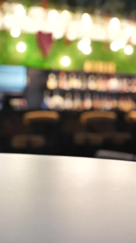 Close-up of a womans hand at a bar, taking a glass of drink. Stock Footage 335808899