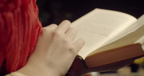 Close up of womans hand on the book while reading, 4k Stock Footage 135376371