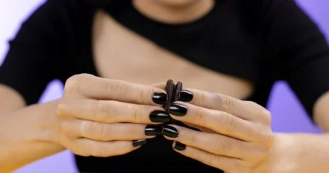Close-up of a woman's hand breaking a chocolate chip cookie Stock Footage 166599965
