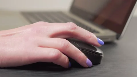 Close-up of a woman's hand clicks the mouse and scrolls the pages. Stock Footage 165154343
