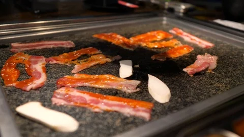 Close-up of woman's hand coocking korean barbecue in a restaurant Stock-Footage 122441951