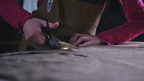 Close-up of woman's hand cutting cloth with scissors Stock Footage 72660984