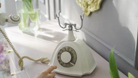 Close-up of woman's hand dialing number on an old retro phone with round disk Stock Footage 172142699