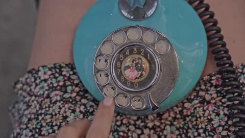 Close-up of a woman's hand dialing a phone number on an old vintage rotating Stock Footage 213988883