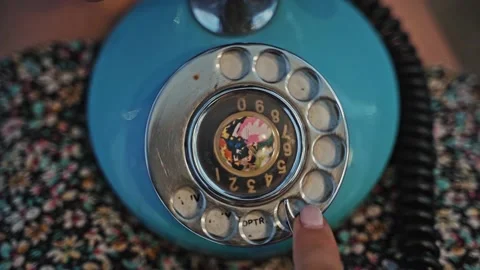 Close-up of a woman's hand dialing a phone number on an old vintage rotating Stock Footage 213988994