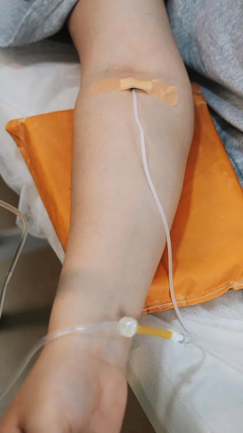 Close-up of a womans hand with a drip of medicine in a modern medical clinic. Stock Footage 313100741
