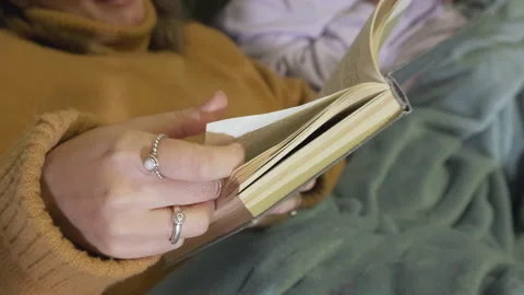Close-Up Of A Woman's Hand Flipping Through A Book, Reading A Novel Stock Footage 139326229