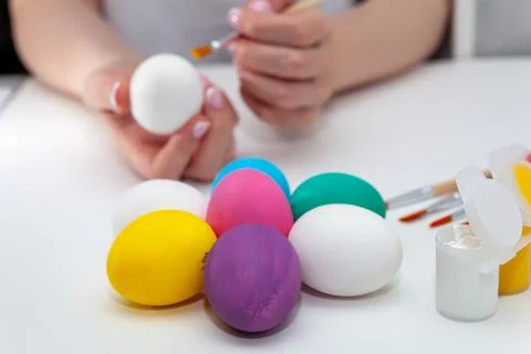 Close-up of a woman's hand holding a complex egg while painting Foto stock