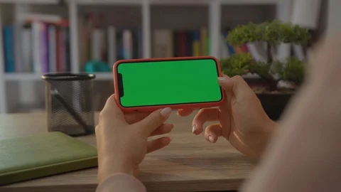 Close up of a Woman's Hand Holding a Mobile Smartphone with a Horizontal Green Stock Footage 116914798
