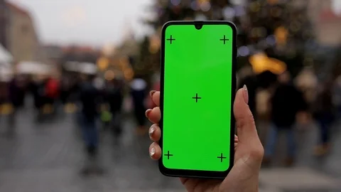 Close up of a woman's hand holding a mobile telephone with a vertical green Stock Footage 126656032