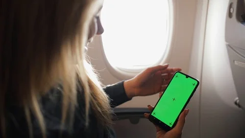 Close up of a woman's hand holding a mobile telephone with a vertical green Stock Footage 129777319
