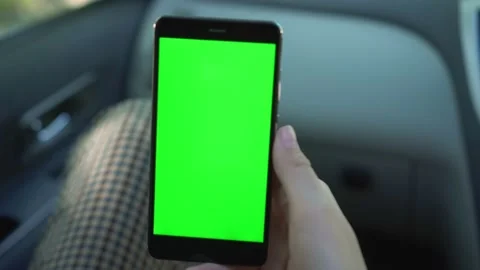 Close up of a woman's hand holding a mobile telephone with a vertical green Stock Footage 134536867