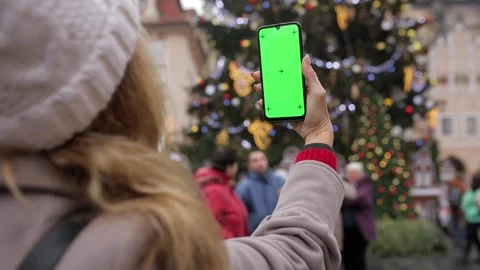 Close up of a woman's hand holding a mobile telephone with a vertical green Stock Footage 135616859