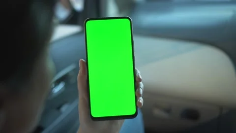 Close up of a woman's hand holding a mobile telephone with a vertical green Stock-Footage 138132689