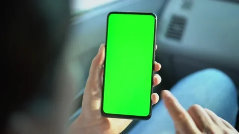 Close up of a woman's hand holding a mobile telephone with a vertical green Stock Footage 138271529