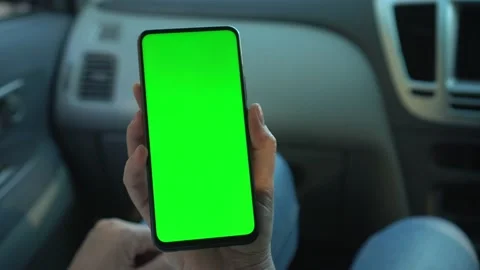 Close up of a woman's hand holding a mobile telephone with a vertical green Stock Footage 138293347