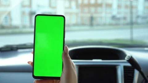 Close up of a woman's hand holding a mobile telephone with a vertical green Stock Footage 140606124