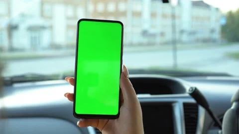 Close up of a woman's hand holding a mobile telephone with a vertical green Stock Footage 140767600