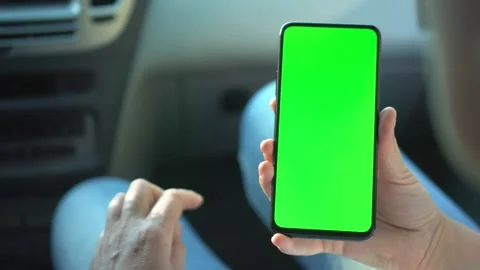 Close up of a woman's hand holding a mobile telephone with a vertical green Stock Footage 148985155