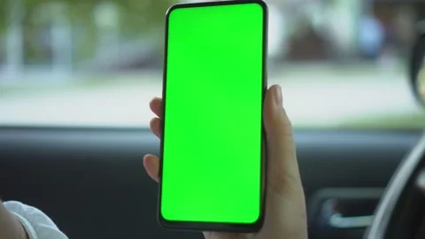 Close up of a woman's hand holding a mobile telephone with a vertical green Stock Footage 149035481