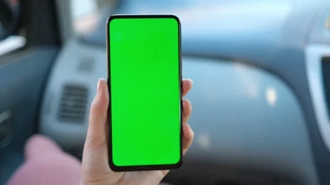 Close up of a woman's hand holding a mobile telephone with a vertical green scre Stock-Footage 155200157
