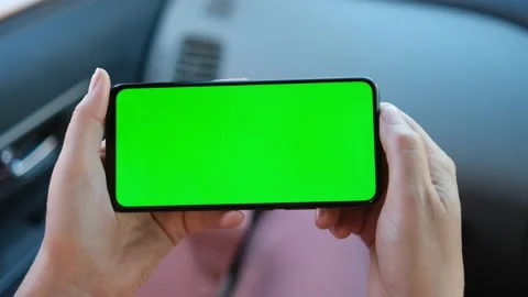 Close up of a woman's hand holding a mobile telephone with a horizontal green Stock Footage 155200418