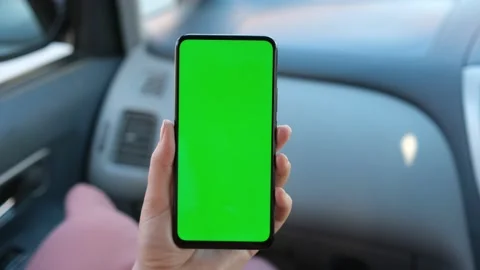 Close up of a woman's hand holding a mobile telephone with a vertical green scre Stock Footage 155257391