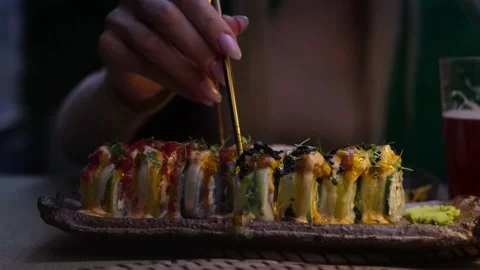 Close-up of woman's hand holding Take Sushi chopsticks and Set of delicious Stock Footage 224277482