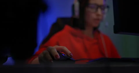 Close-up, a woman's hand holds a mouse, a girl plays at the computer. Beautiful Stock Footage 154384803