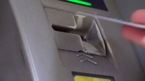 Close-up of a woman's hand inserting a credit card into an ATM. Stock Footage 125952152