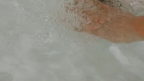 Close-up of a woman's hand in the Jacuzzi Stock Footage 105659847