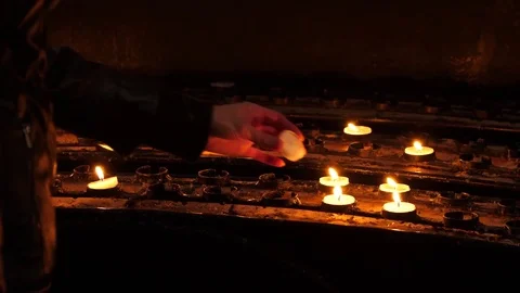 Close up of a woman's hand lighting a prayer candle in a church Video stock 82525550