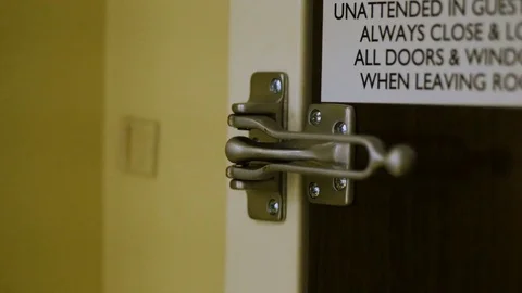 Close-up Of Woman's Hand Locking Deadbolt Lock At Hotel Stock-Footage 75969234