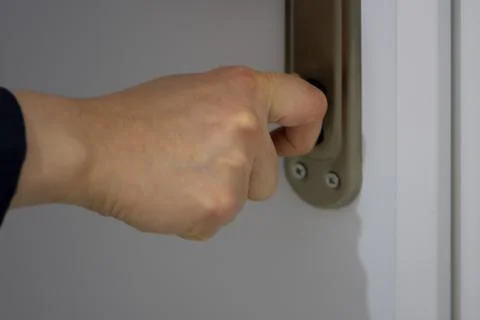 Close up of woman's hand locking or unlocking the door Stock Photos