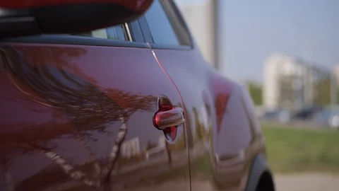 Close-up. A woman's hand opens the car door, sits inside. 4K Slow Mo Stock Footage 107827964