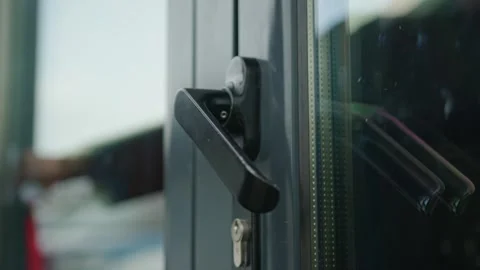 Close-up of a woman's hand opens the door handle in black to enter the room Stock Footage 240329477