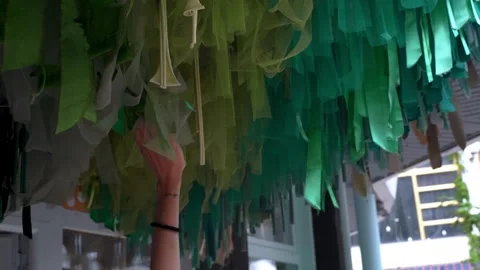 Close-up of a woman's hand passing along the old fishing nets hanging from the Stock Footage 280182415