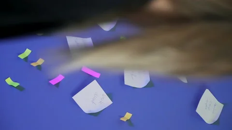 Close-up. A woman's hand is pasting a sticker on a wall Stock Footage 165513537