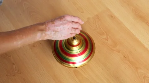 Close-up of a woman's hand playing with a rotating yula toy. Vitiligo Stock Footage 257439423
