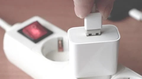 Close-up of a woman's hand plugs a USB cable into a USB port to charge Video stock 171065416