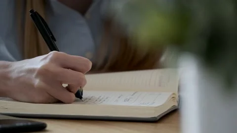 Close-up of a woman's hand pointing and underlining in the papers about a new pr Video stock 154516920