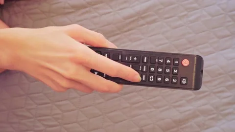 Close-up a woman's hand presses her index finger on the red button to turn on Stock Footage 202188678