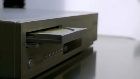 Close-up woman's hand pulls out an old CD from a dvd player. Stock Footage 226410003