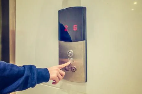 Close-up of woman's hand pushing a button of elevator Foto stock