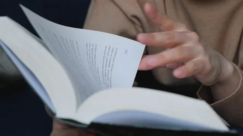 Close Up Of A Woman's Hand Reading A Book And Turning The Page Stock Footage 134945177