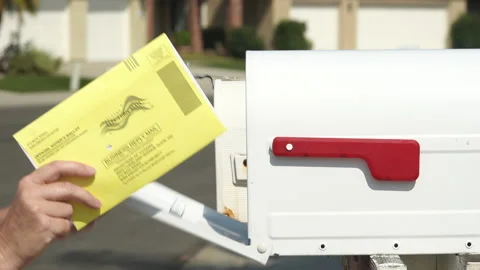 Close up of a woman's hand returning mail ballot, putting into post box. Stock Footage 140680256