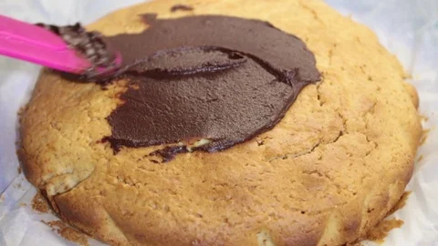 Close-up, woman's hand rolling out chocolate over a cake Video stock 120737025