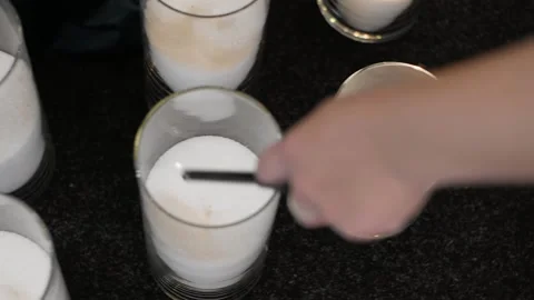 Close-up of a woman's hand that sets fire to large candles Stock Footage 152067365